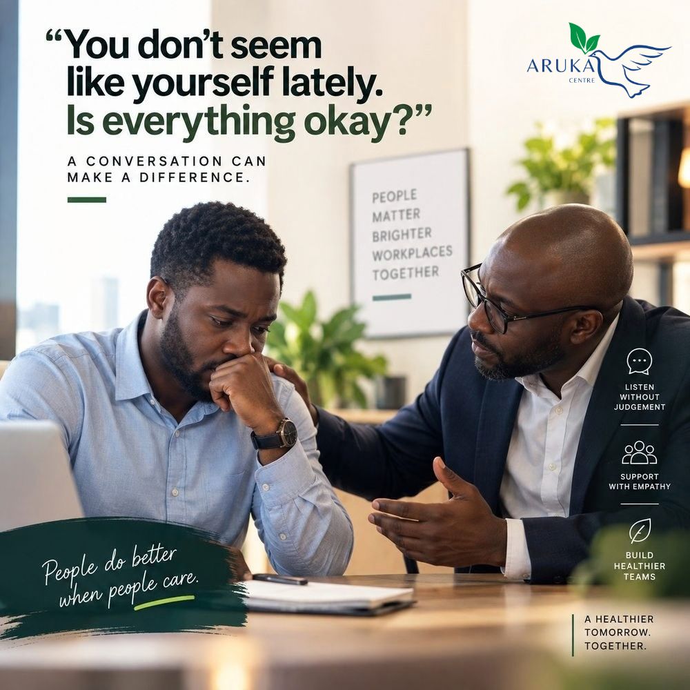 Two colleagues in conversation — a manager checking in with a team member who seems withdrawn